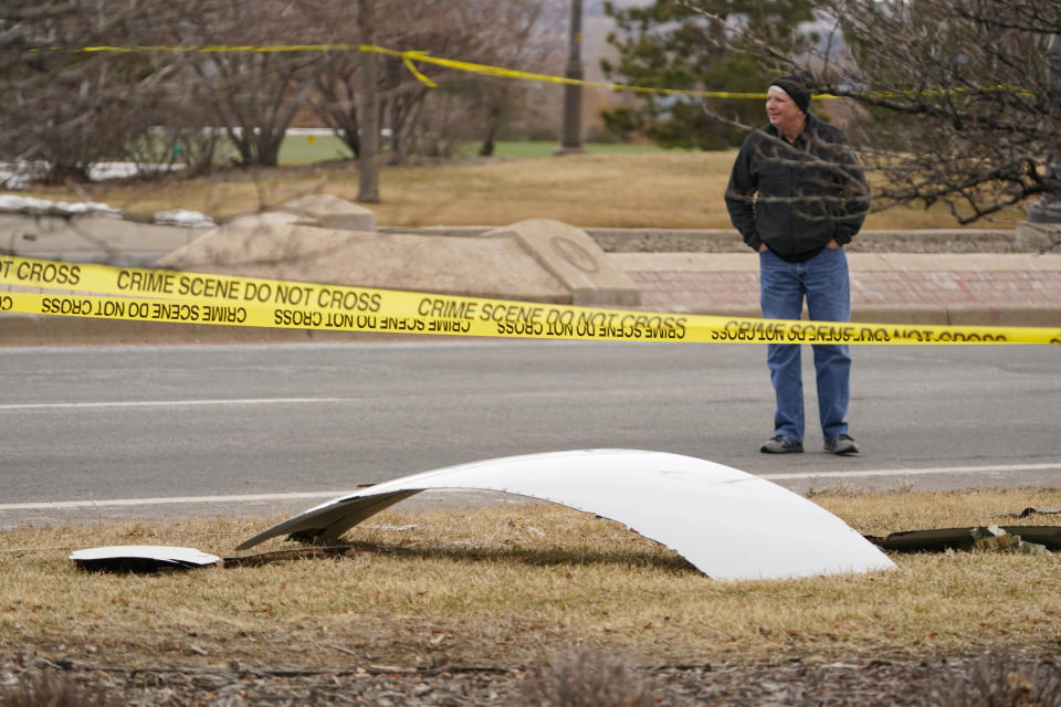 A piece of debris from a commercial airplane is surrounded by police tape on a strip along Midway Boulevard in Broomfield, Colo., after the plane shed parts while making an emergency landing at nearby Denver International Airport Saturday, Feb. 20, 2021. (AP Photo/David Zalubowski)