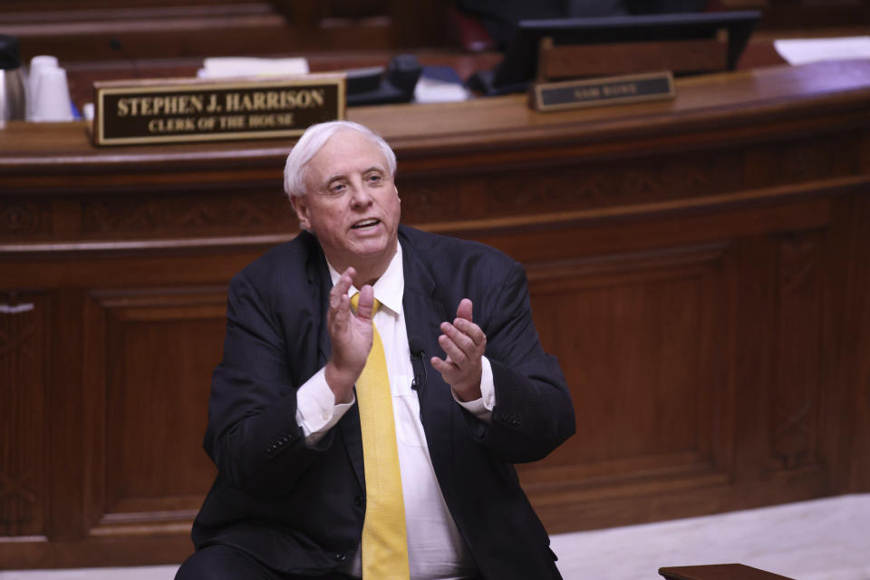 West Virginia Governor Jim Justice applauds the West Virginia Supreme Court Justices during the State of the State Address in the House Chambers of the West Virginia State Capitol Building in Charleston, W.Va., on Wednesday, Feb. 10, 2021. (AP Photo/Chris Jackson)