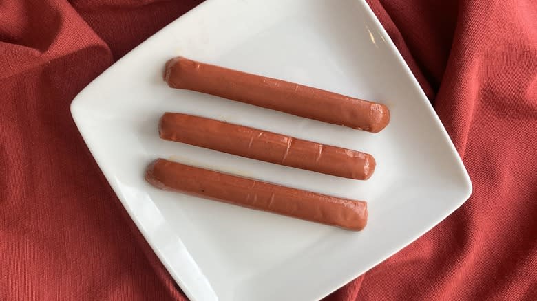 three plant hot dogs on plate