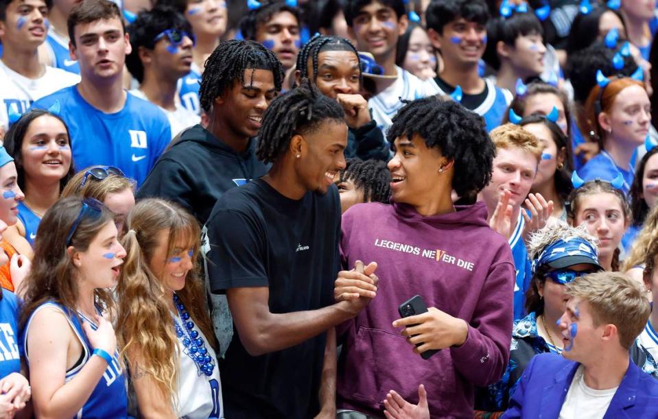 Duke basketball commit Mackenzie Mgbako, bottom left, greets recruit Dylan Harper, bottom right, as they stand with basketball commits Sean Stewart, top left, and Caleb Foster, top right, during Duke’s Countdown to Craziness at Cameron Indoor Stadium in Durham, N.C., Friday, Oct. 21, 2022.