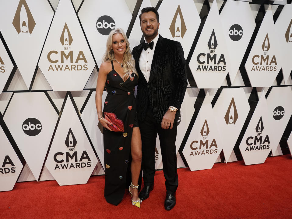 Luke Bryan, right, and Caroline Boyer arrive at the 55th annual CMA Awards on Wednesday, Nov. 10, 2021, at the Bridgestone Arena in Nashville, Tenn. (AP Photo/Ed Rode)