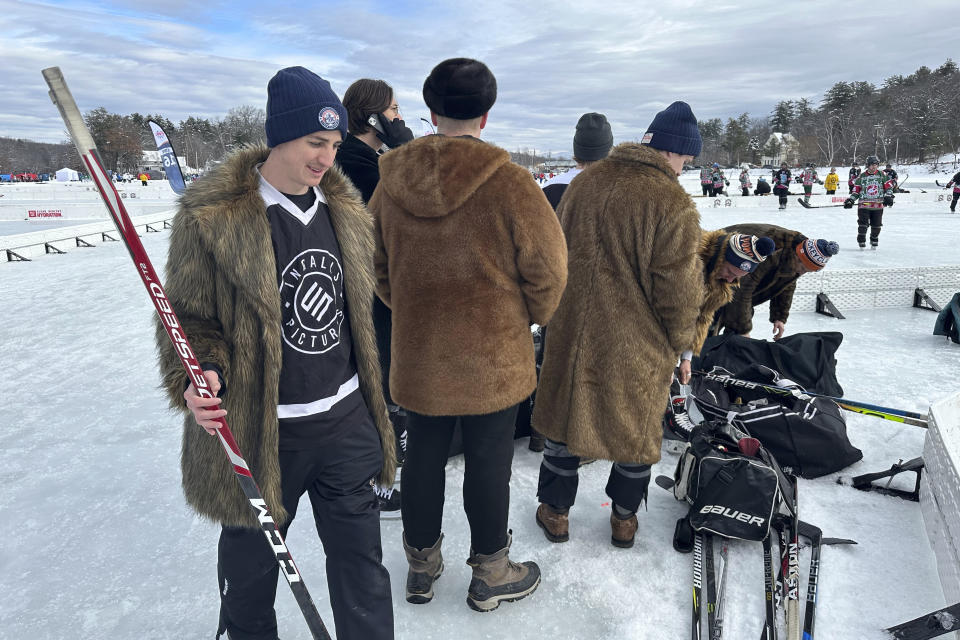 A hockey team decked out in furry coats gets ready to play at the Pond Hockey Classic in Meredith, N.H., on Friday, Feb. 2, 2024. (AP Photo/Nick Perry)