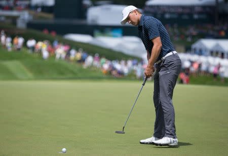 Jun 25, 2017; Cromwell, CT, USA; Jordan Spieth makes a birdie putt on the 1st hole during the final round of the Travelers Championship golf tournament at TPC River Highlands. Mandatory Credit: Bill Streicher-USA TODAY Sports
