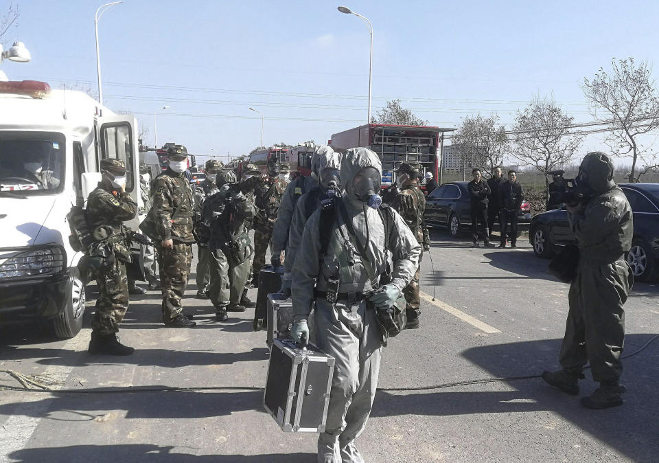 Emergency personnel wearing protective clothing prepare to work at the site of a factory explosion in a chemical industrial park in Xiangshui County of Yancheng in eastern China's Jiangsu province, Friday, March 22, 2019. The local government reports the death toll in an explosion at a chemical plant in eastern China has risen with dozens killed and more seriously injured. (Chinatopix via AP)