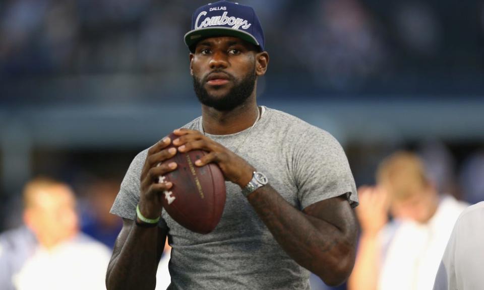 Lebron James throws a football at AT&T Stadium before a game in 2013.