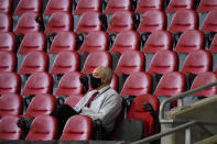 A man watches teams warm up before the first half of an NFL football game between the Atlanta Falcons and the Chicago Bears, Sunday, Sept. 27, 2020, in Atlanta. (AP Photo/Brynn Anderson)