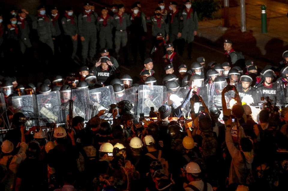 Pro-democracy activists confront a police blockage during their march to the Government House, prime minister's office during a protest march in Bangkok, Thailand, Wednesday, Oct. 21, 2020. Thailand's prime minister on Wednesday pleaded with his countrymen to resolve their political differences through Parliament, as student-led protests seeking to bring his government down continued for an eighth straight day. (AP Photo/Sakchai Lalit)