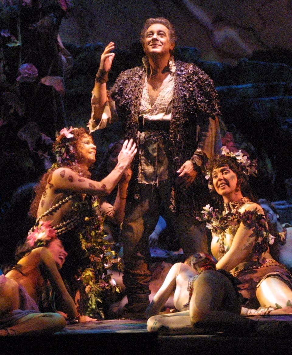 ARCHIVO - En esta imagen de archivo del lunes 26 de marzo de 2001, Plácido Domingo aparece rodeado de actrices vestidas como doncellas-flores mientras interpreta el papel protagonista en "Parsifal", durante un ensayo de vestuario en la Ópera Metropolitana de Nueva York. (AP Foto/Stuart Ramson)