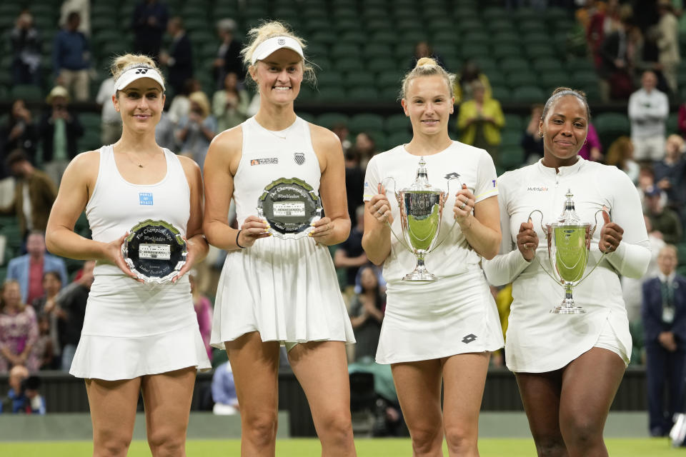 Taylor Townsend, right, of the United States and Katerina Siniakova of the Czech Republic hold their trophy's after defeating Gabriela Dabrowski, left, of Canada and Erin Routliffe of New Zealand in the women's doubles final at the Wimbledon tennis championships in London, Saturday, July 13, 2024. (AP Photo/Alberto Pezzali)