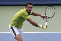 Marin Cilic, of Croatia, returns a backhand against Radu Albot, of Moldova, during first round play at the Western & Southern Open tennis tournament, Monday, Aug. 12, 2019, in Mason, Ohio. (AP Photo/Gary Landers)