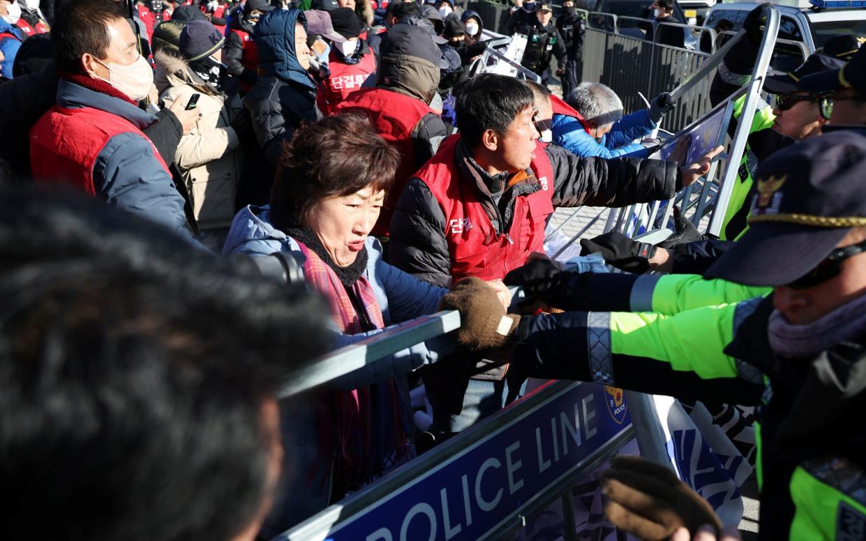 Dog farmers scuffle with South Korean policemen during a protest to demand the government scrap plans to pass a bill to enforce a ban on eating dog meat, in front of the Presidential Office in Seoul