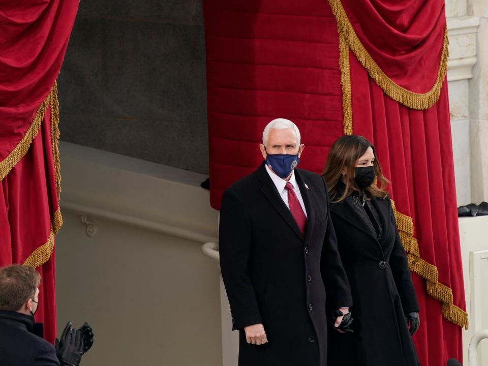 Vice President Mike Pence and Karen Pence arrive at the inauguration of Joe Biden on the West Front of the US Capitol. Mr Pence is attending the inauguration ceremony despite the absence of President Donald Trump, who left Washington before the ceremony beganAP