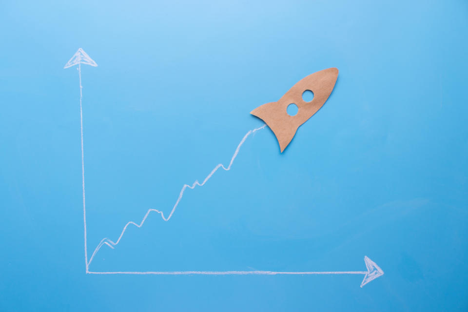 A brown paper rocket set to look like it's shooting higher on a white, hand-drawn chart, set against a light-blue background.