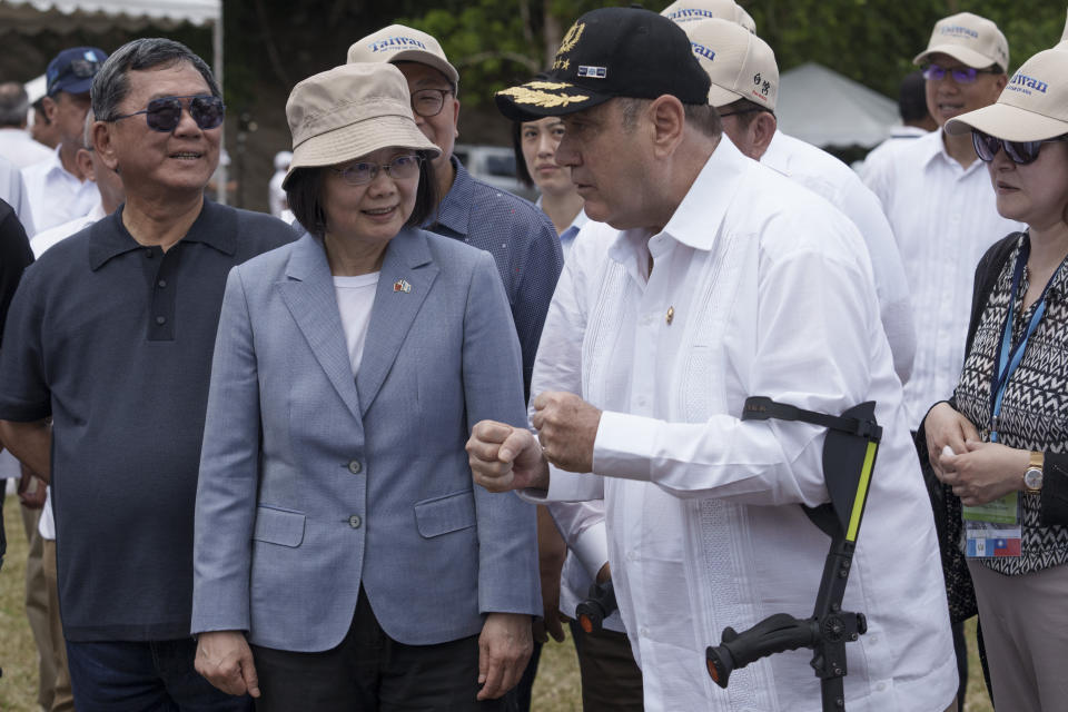 Taiwan's President Tsai Ing-wen and Guatemala's President Alejandro Giammattei, speak with reporters during their visit to the Mayan site Tikal, in Peten, Guatemala, Saturday, April 1, 2023. Tsai is in Guatemala for an official three-day visit. (AP Photo/Moises Castillo)