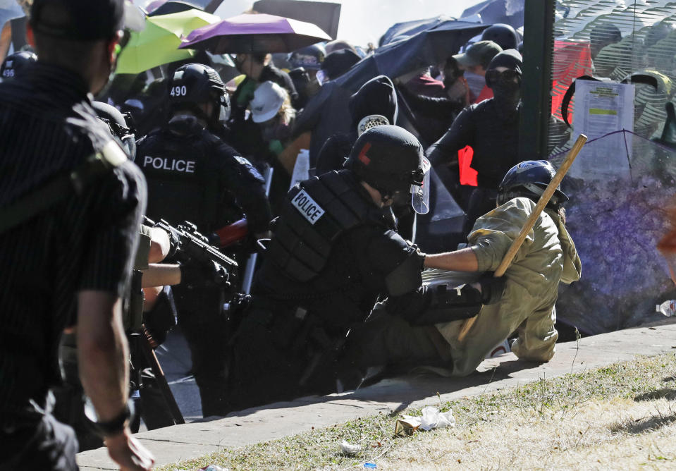 Police take down a protester, Saturday, July 25, 2020, near Seattle Central Community College in Seattle. A large group of protesters were marching Saturday in Seattle in support of Black Lives Matter and against police brutality and racial injustice. (AP Photo/Ted S. Warren)