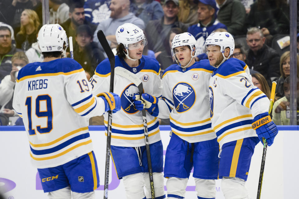 Buffalo Sabres' JJ Peterka (77) celebrates his goal against the Toronto Maple Leafs with Peyton Krebs (19), Owen Power (25) and Kyle Okposo (21) during the first period of an NHL hockey game Saturday, Nov. 4, 2023, in Toronto. (Christopher Katsarov/The Canadian Press via AP)