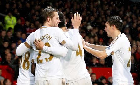 Football Soccer - Manchester United v Swansea City - Barclays Premier League - Old Trafford - 2/1/16 Gylfi Sigurdsson celebrates with team mates after scoring the first goal for Swansea Action Images via Reuters / Carl Recine Livepic