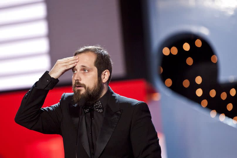 Spanish film director, Carlos Vermut, gestures after receiving the Silver Shell for the best director with his film, '' Magical Girl'.