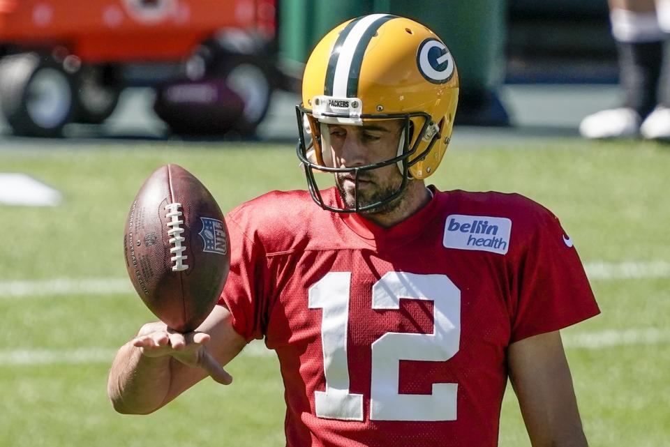 FILE - Green Bay Packers' Aaron Rodgers plays with a football during NFL football practice Friday, Sept. 4, 2020, in Green Bay, Wis. Aaron Rodgers will begin his 16th season with Green Bay looking to continue his remarkable run of success against NFC North opponents as the Packers visit Minnesota. The Packers own a 47-18-1 record in games Rodgers has played against NFC North foes, including a 6-0 mark last season. (AP Photo/Morry Gash, File)