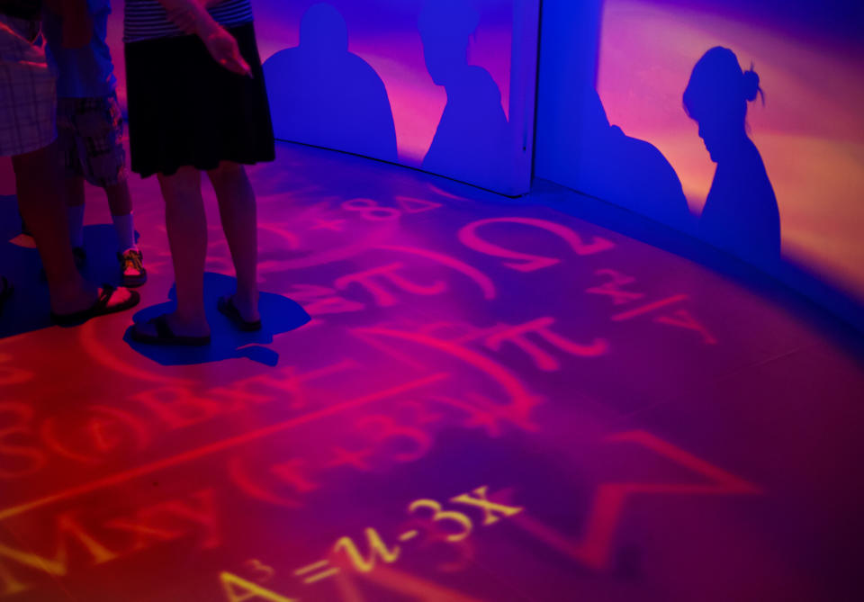 In this Friday, Aug. 9, 2013 photo, formulas are cast on the floor during a tour of the vault containing the “secret recipe” for Coca-Cola, in Atlanta. The 127-year-old recipe for Coke sits inside an imposing steel vault that’s bathed in red security lights, while security cameras monitor the area to make sure the fizzy formula stays a secret. (AP Photo/David Goldman)