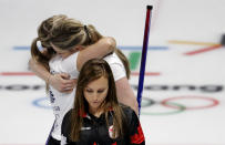 <p>Canada’s skip Rachel Homan, center, leaves the ice as Britain’s Lauren Gray, right above, and Vicki Adams embrace celebrating winning a women’s curling match at the 2018 Winter Olympics in Gangneung, South Korea, Wednesday, Feb. 21, 2018. (AP Photo/Natacha Pisarenko) </p>