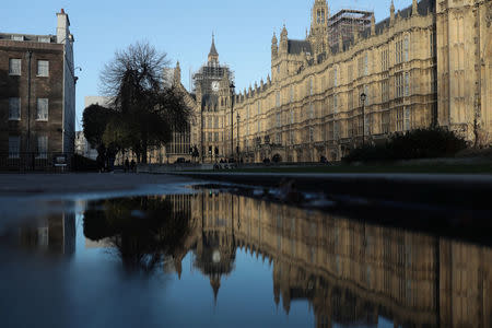 Britain's Houses of Parliament is seen reflected in a large puddle in Westminster in London, Britain, January 3, 2018. REUTERS/Simon Dawson