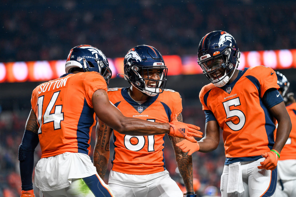 DENVER, COLORADO - AUGUST 28:  Courtland Sutton #14 of the Denver Broncos celebrates with Teddy Bridgewater #5 and Tim Patrick #81 after a second quarter touchdown against the Los Angeles Rams at Empower Field at Mile High on August 28, 2021 in Denver, Colorado. (Photo by Dustin Bradford/Getty Images)