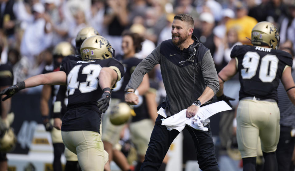 Colorado safety Trevor Woods, left, celebrates with interim head coach Mike Sanford after stopping California in the first half of an NCAA college football game in Folsom Field Saturday, Oct. 15, 2022, in Boulder, Colo. (AP Photo/David Zalubowski)