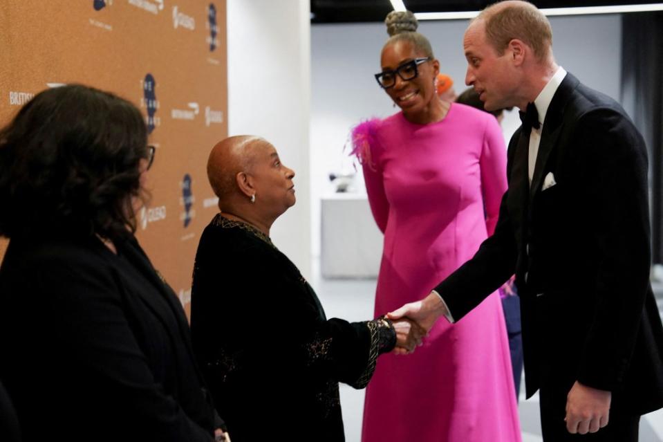 William, next to Diana Award Chief Executive Tessy Ojo, shakes hands as he attends the Diana Legacy Awards. via REUTERS