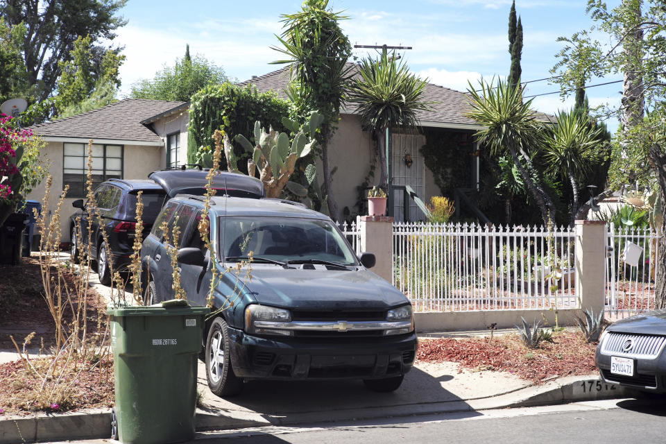 Cars are parked in the driveway of Robert Chain's house in the Encino section of Los Angeles on Thursday, Aug. 30, 2018. Chain, who was upset about The Boston Globe's coordinated editorial response to President Donald Trump's attacks on the news media, was arrested Thursday for threatening to travel to the newspaper's offices and kill journalists, whom he called the "enemy of the people," federal prosecutors said. (David Crane/Los Angeles Daily News via AP)