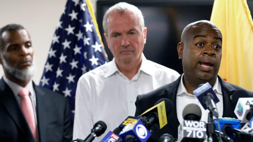 An August 2019 press conference at the Newark Health Department shows Newark Mayor Ras Baraka speaking about Newark’s ongoing water crisis. At left is Kareem Addem, acting director of Water and Sewer Utilities in Newark, and New Jersey Gov. Phil Murphy. (Photo by Rick Loomis/Getty Images)
