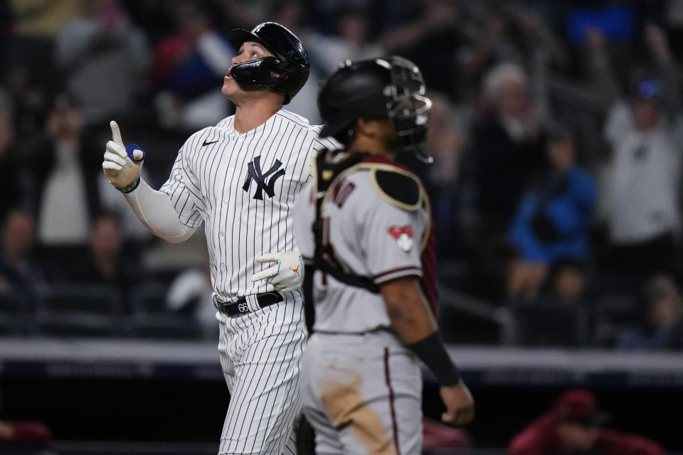 New York Yankees' Aaron Judge gestures as he passes Arizona Diamondbacks catcher Gabriel Moreno while scoring on a two-run home run during the fifth inning of a baseball game Friday, Sept. 22, 2023, in New York. (AP Photo/Frank Franklin II)