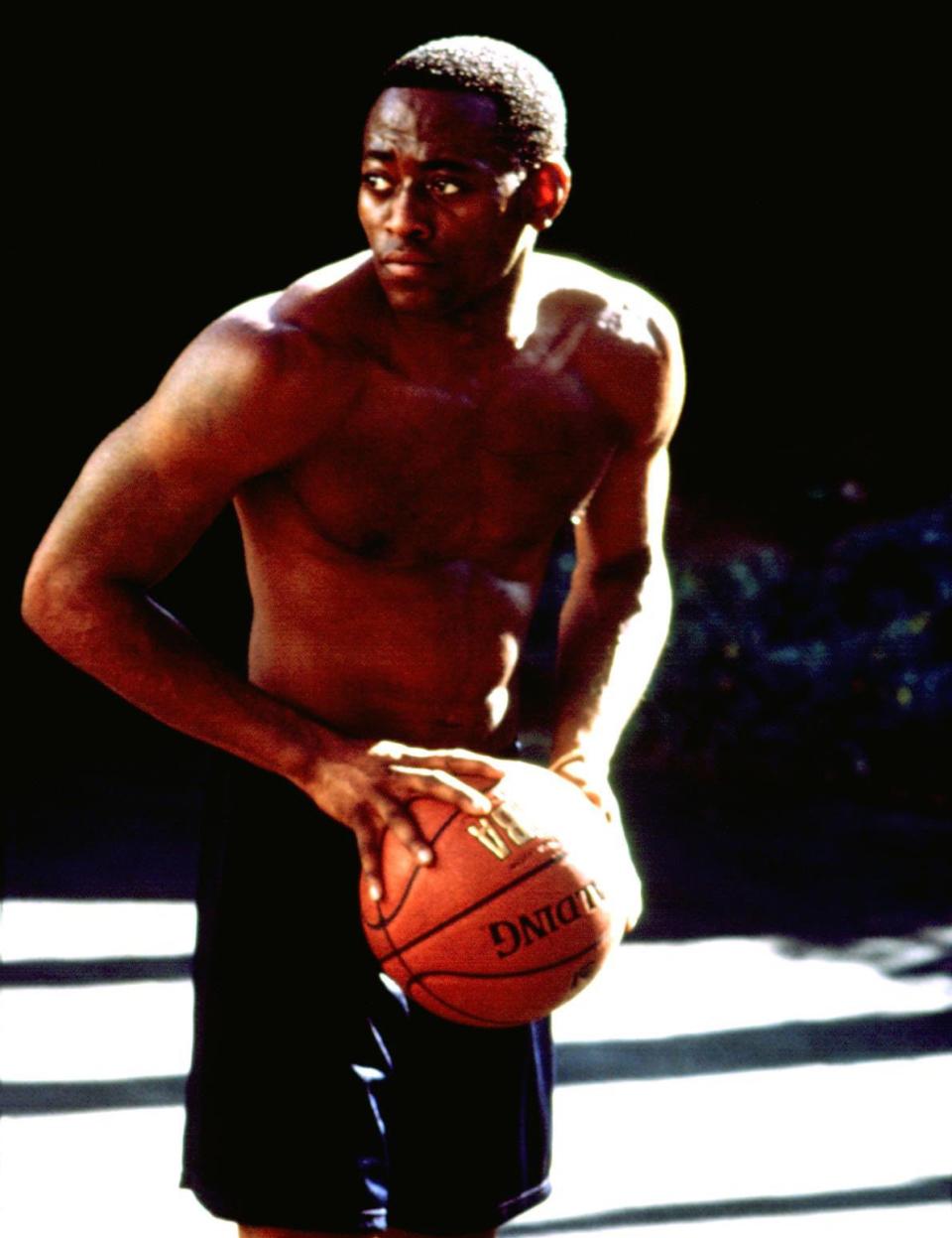 Bare-chested Omar playing basketball