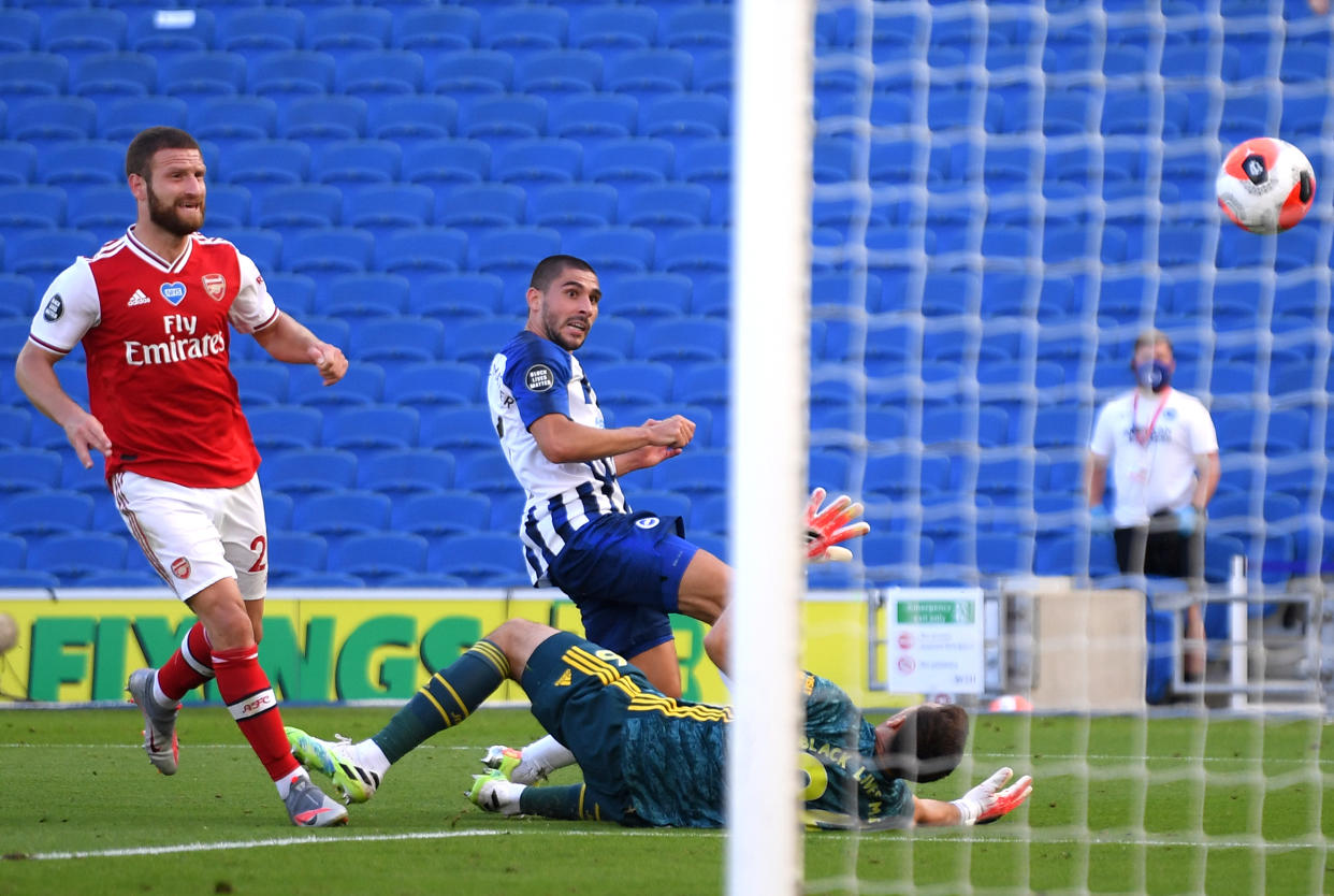 BRIGHTON, ENGLAND - JUNE 20: Neal Maupay of Brighton and Hove Albion scores his team's second goal past Emiliano Martinez of Arsenal during the Premier League match between Brighton & Hove Albion and Arsenal FC at American Express Community Stadium on June 20, 2020 in Brighton, England. Football Stadiums around Europe remain empty due to the Coronavirus Pandemic as Government social distancing laws prohibit fans inside venues resulting in all fixtures being played behind closed doors. (Photo by Mike Hewitt/Getty Images)