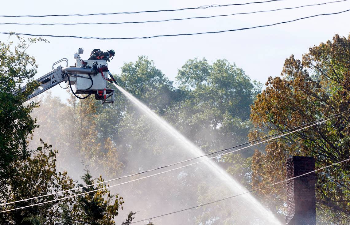 Firefighters work the scene of a fire at a building near the intersection of East Main Street and Holman Street on Thursday, May 2, 2024, in Durham, N.C.