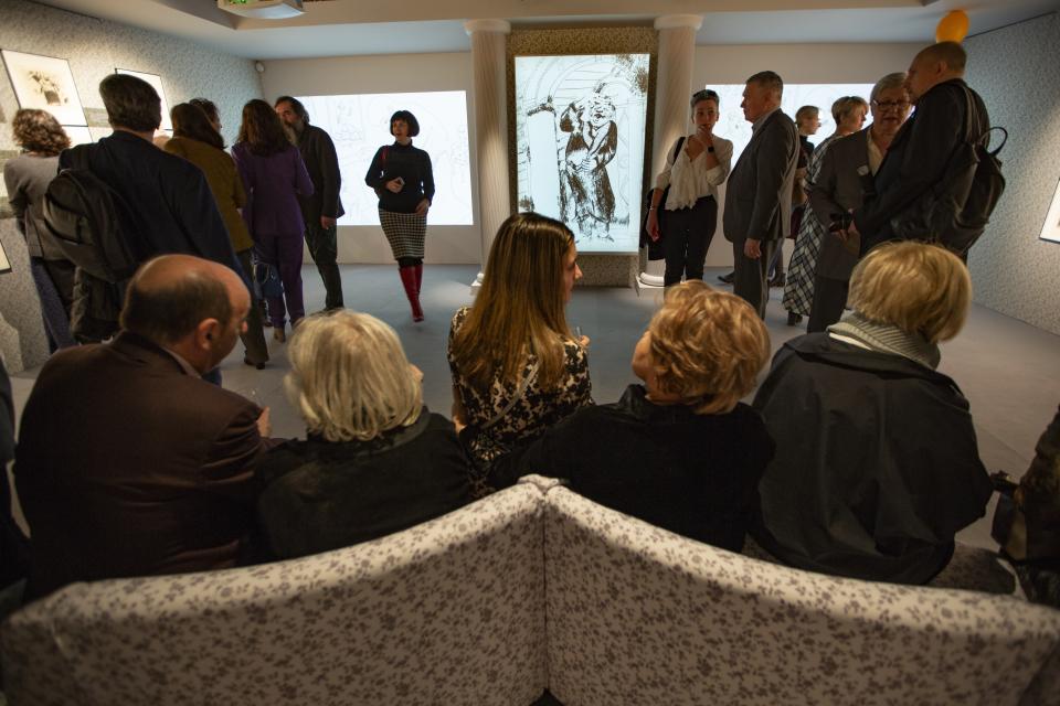 In this photo taken on Monday, March 18, 2019, visitors look at an exhibition of Marc Chagall illustrations for "Dead Souls", a novel by Nikolai Gogol at the AZ Museum, in Moscow, Russia. The AZ Museum was opened in 2015 in Moscow, named after Anatoly Zverev whose portrait of a young woman was Natalia Opaleva's first purchase. (AP Photo/Alexander Zemlianichenko)