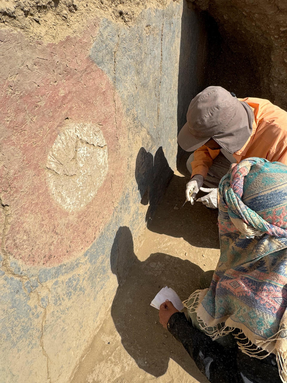Archaeologists work on what's believed to be part of a 4,000-year-old ceremonial temple, found buried in a sand dune of northern Peru, in Lambayeque / Credit: Peru's Pontifical Catholic University/Handout via REUTERS