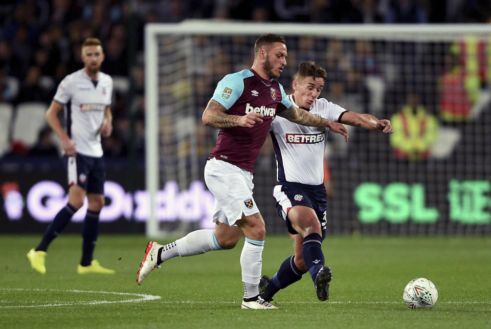 West Ham United’s Marko Arnautovic, left, and Bolton Wanderers’ Jeff King battle for the ball during their English League Cup, third round soccer match at the London Stadium in London, Tuesday, Sept. 19, 2017. (Daniel Hambury/PA via AP)