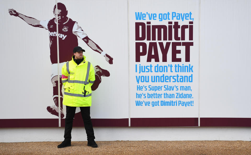 A steward makes sure Dimitri Payet’s picture is not graffitied as he pushed for a move from West Ham