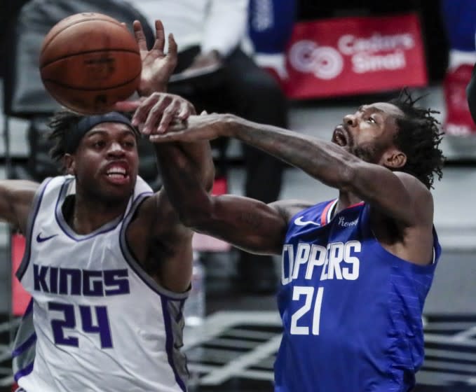 Los Angeles, CA, Wednesday, January 20, 2021 -Sacramento Kings guard Buddy Hield (24) blocks the shot of LA Clippers guard Patrick Beverley (21) during first half action at Staples Center. (Robert Gauthier/Los Angeles Times)