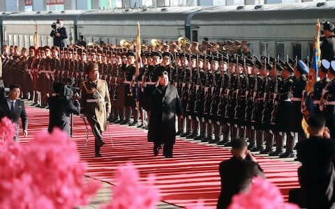 North Korean leader Kim Jong-un inspects a guard of honour before boarding the train at Pyongyang Station - Credit: AFP