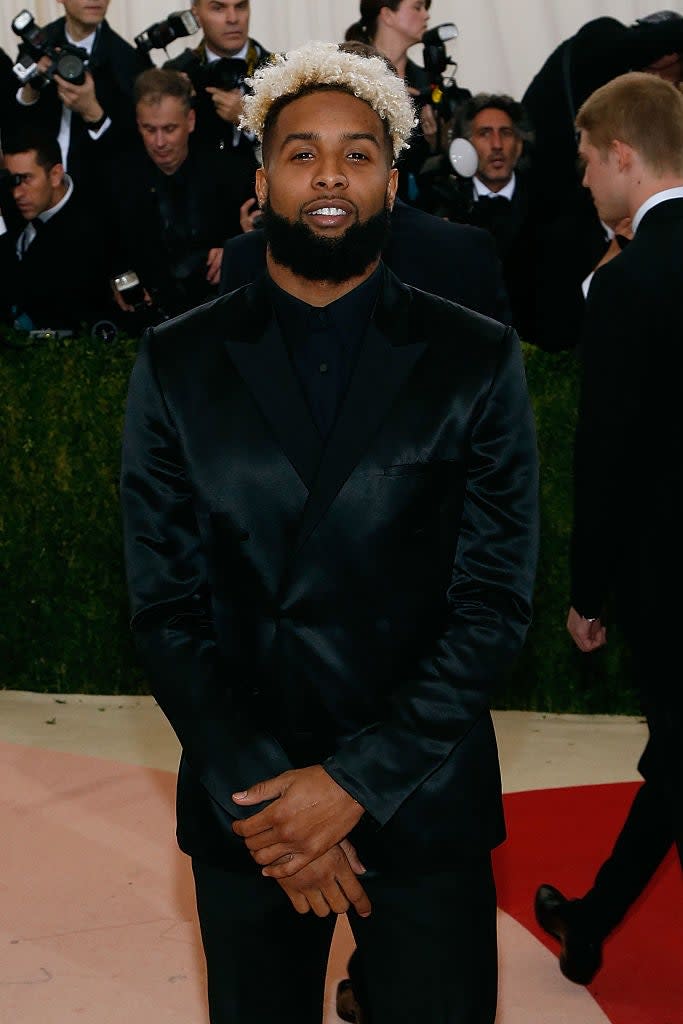 Odell Beckham Jr. in a velvet suit standing on the red carpet