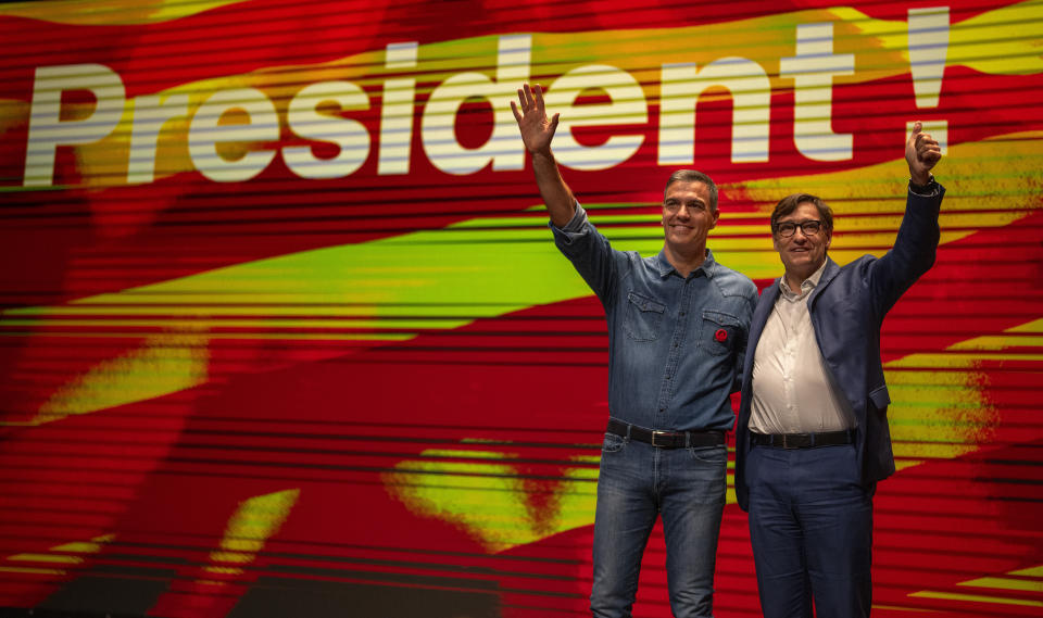 Spanish Prime Minister Pedro Sanchez and socialist candidate, Salvador Illa, right, wave to the crowd during a campaign rally in Villanova i la Gertru, near Barcelona, Spain, Thursday, May 9, 2024. Some nearly 6 million Catalans are called to cast ballots in regional elections on Sunday that will surely have reverberations in Spain's national politics. (AP Photo/Emilio Morenatti)