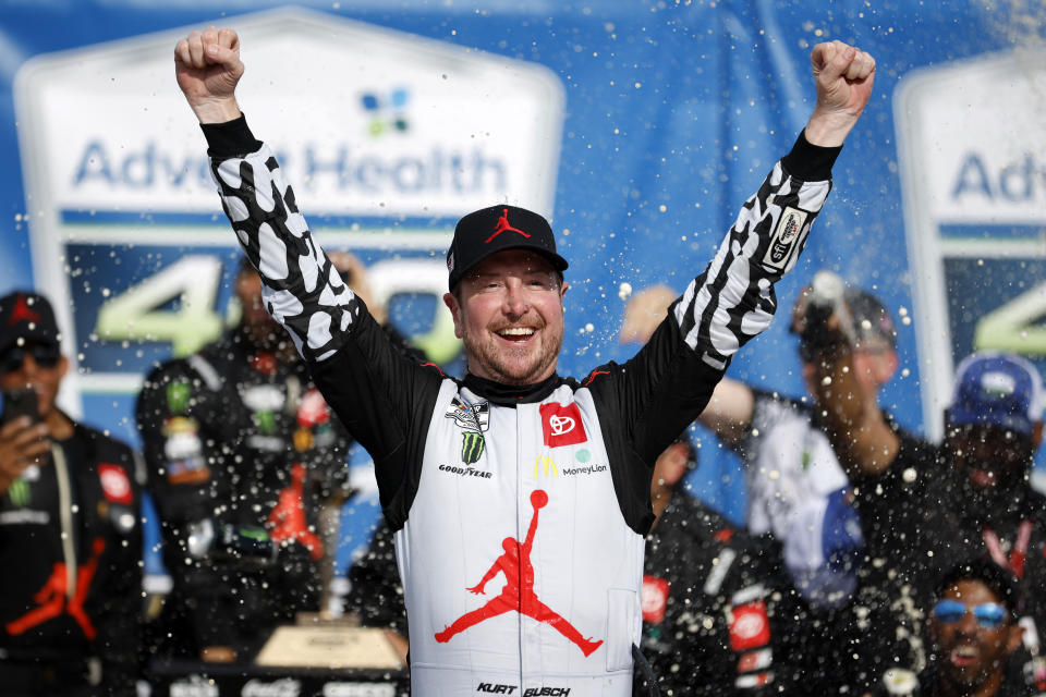 FILE - Kurt Busch celebrates in victory lane after winning a NASCAR Cup Series auto race at Kansas Speedway in Kansas City, Kan., Sunday, May 15, 2022. Busch announced Saturday, Oct. 15 he will miss the rest of this season with a concussion and will not compete full-time in 2023. The 44-year-old made his announcement at Las Vegas Motor Speedway, his home track and where he launched his career on the bullring as a child. He choked up when he said doctors told him “it is best for me to ‘shut it down.'” (AP Photo/Colin E. Braley, File)