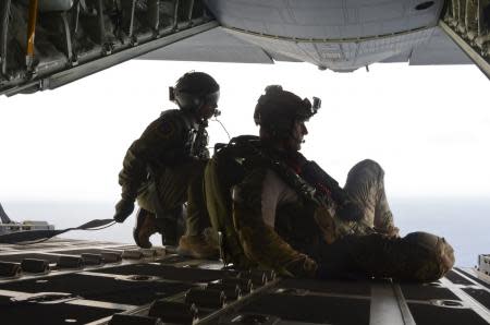 In this May 3, 2014, image provided by the U.S. Air Force, Airman 1st Class Franscisco Harper, left, and a pararescue Airman survey the area as U.S. Air Force pararescue forces parachute into the Pacific Ocean to aid to two critically injured sailors aboard a Venezuelan fishing boat. The Venezuelan fishing boat found the sailors floating in a raft Friday afternoon after their vessel sank off the coast of Mexico, said Sarah Schwennese, spokeswoman at the Davis-Monthan Air Force Base in Tucson. (AP Photo/U.S. Air Force, Staff Sgt. Adam Grant)