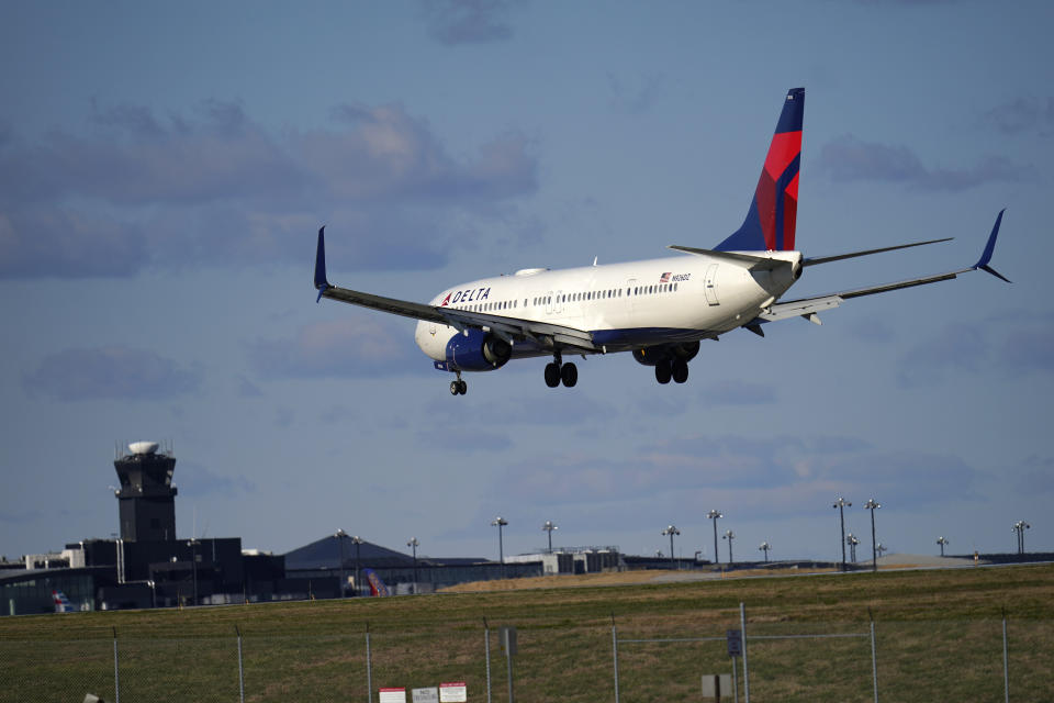 A Delta Airlines flight from Atlanta makes its landing approach onto Baltimore-Washington International Thurgood Marshall Airport, Monday, Nov. 23, 2020, in Glen Burnie, Md. (AP Photo/Julio Cortez)