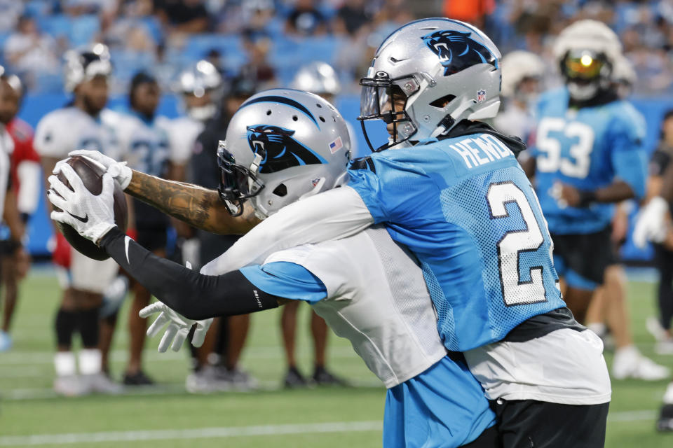 Carolina Panthers wide receiver Robbie Anderson, right, catches a pass against cornerback C.J. Henderson at the NFL football team's Fan Fest in Charlotte, N.C., Thursday, Aug. 11, 2022. (AP Photo/Nell Redmond)