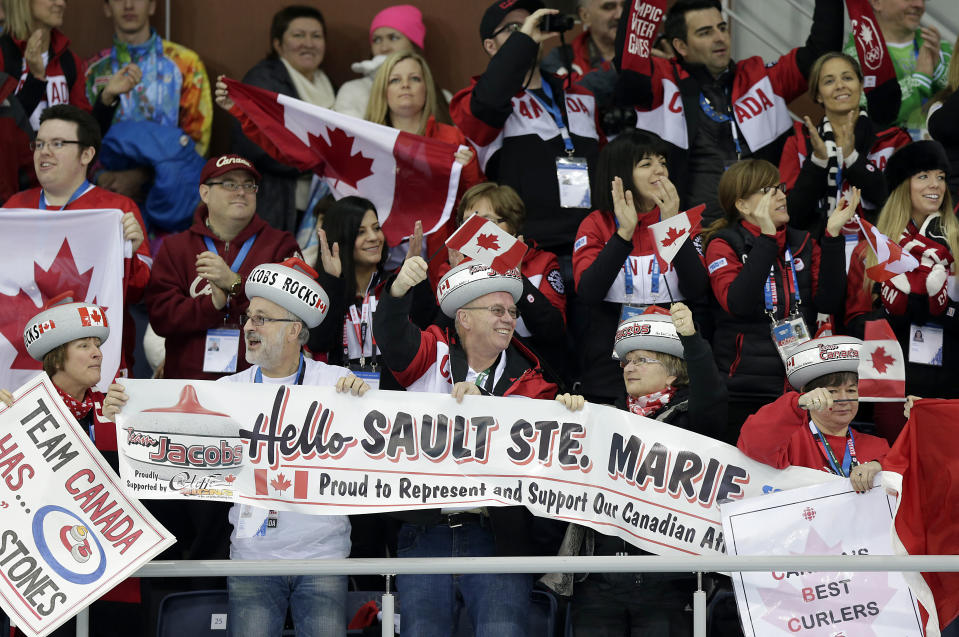 Supporters of Canada's curling team celebrate after they beat Germany during the men's curling competition at the 2014 Winter Olympics, Monday, Feb. 10, 2014, in Sochi, Russia. (AP Photo/Wong Maye-E)