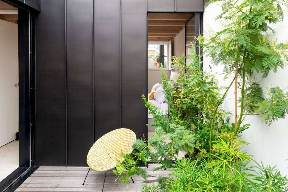 Lush and leafy, the second-floor terrace adds life to the interior.