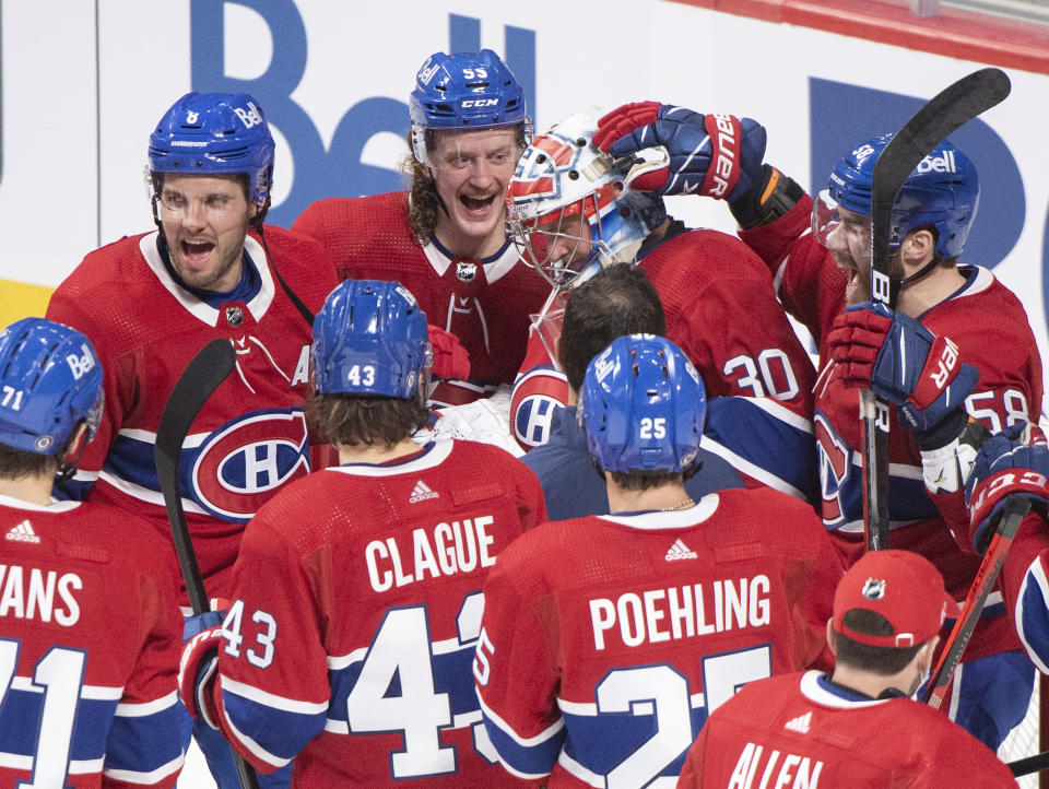 Montreal Canadiens players congratulate goaltender Cayden Primeau after defeating the Philadelphia Flyers in an NHL hockey game in Montreal, Thursday, Dec. 16, 2021. (Graham Hughes/The Canadian Press via AP)